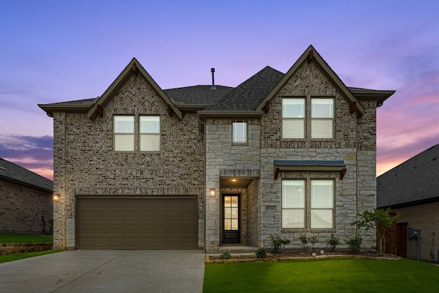 view of front facade featuring a lawn and a garage