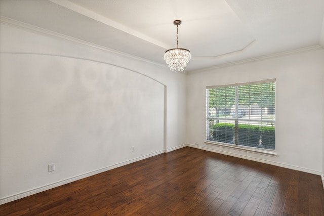 spare room with ornamental molding, a notable chandelier, and dark wood-type flooring