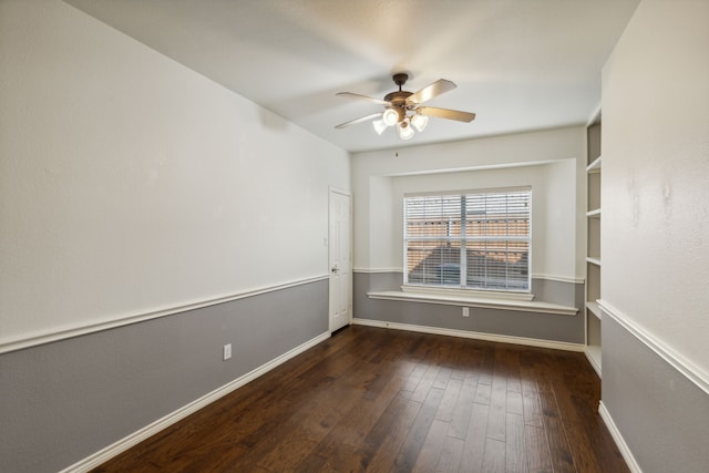 empty room with ceiling fan and dark hardwood / wood-style flooring