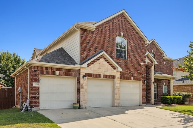 front facade featuring a garage and a front lawn