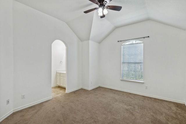 interior space featuring ceiling fan and vaulted ceiling