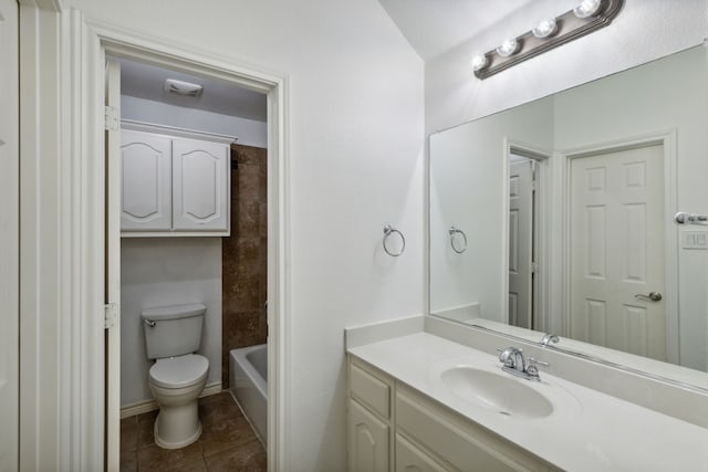 bathroom with vanity, tile patterned flooring, and toilet