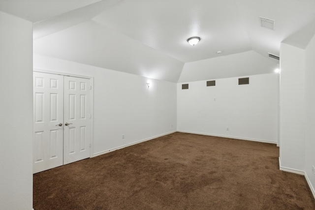 carpeted spare room with lofted ceiling