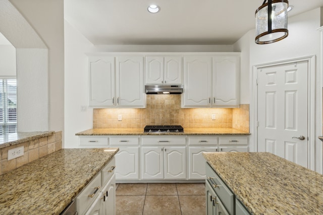 kitchen with light stone counters, white cabinets, and black gas cooktop