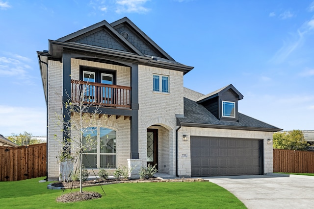 view of front of house featuring a balcony, a front yard, and a garage