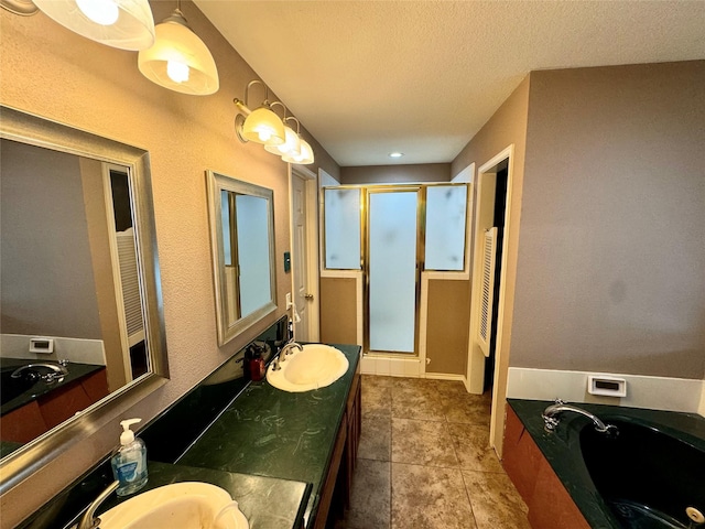 bathroom featuring tile patterned floors, vanity, separate shower and tub, and a textured ceiling