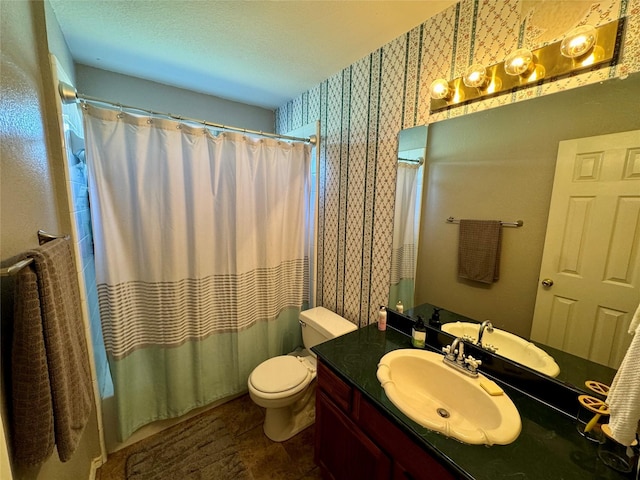 bathroom featuring vanity, toilet, and walk in shower