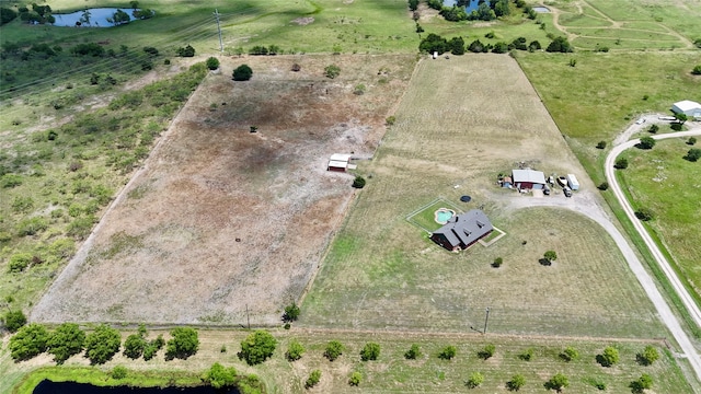 birds eye view of property featuring a rural view and a water view