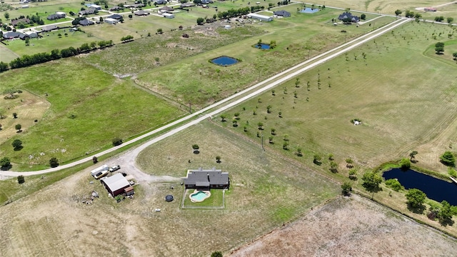 drone / aerial view featuring a water view and a rural view