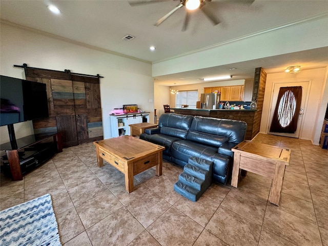 tiled living room featuring ceiling fan, a barn door, and crown molding