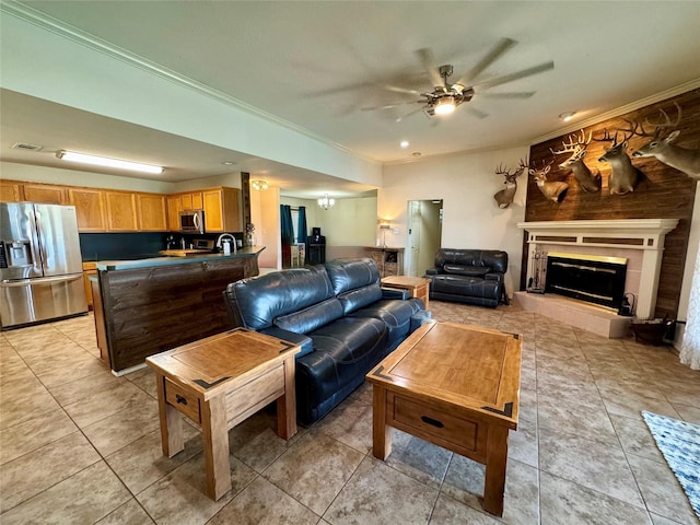 tiled living room with a tiled fireplace, crown molding, and ceiling fan