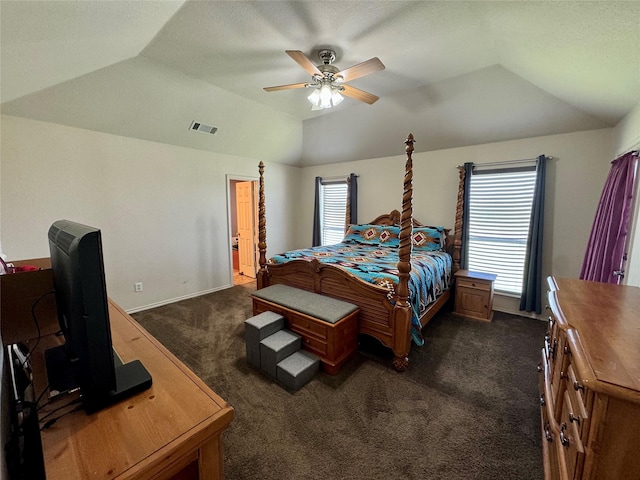 carpeted bedroom featuring a raised ceiling, ceiling fan, and vaulted ceiling