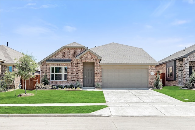 view of front of home featuring a front yard and a garage