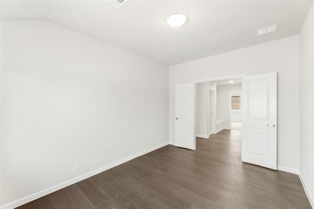 spare room with dark wood-type flooring