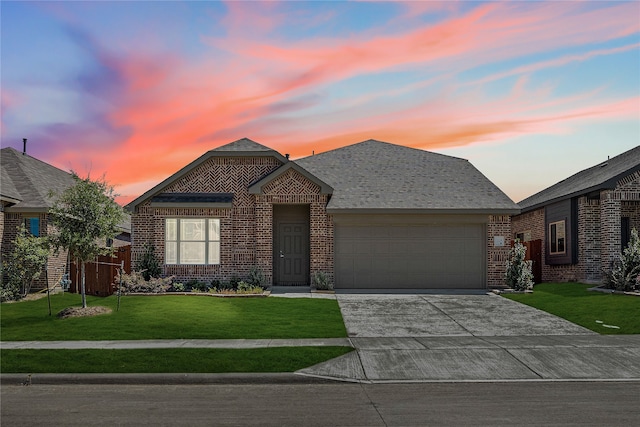 view of front of property featuring a lawn and a garage