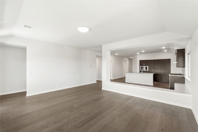 unfurnished living room featuring hardwood / wood-style flooring and lofted ceiling