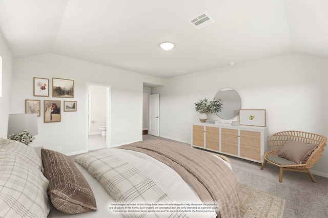 bedroom with carpet, vaulted ceiling, and ensuite bath