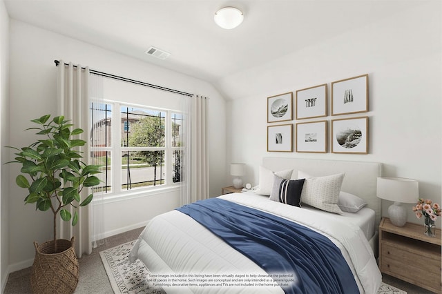 carpeted bedroom featuring lofted ceiling