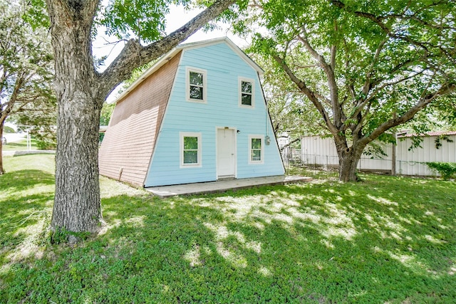 rear view of house featuring a yard