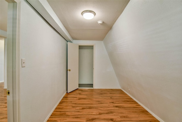 corridor with light hardwood / wood-style flooring