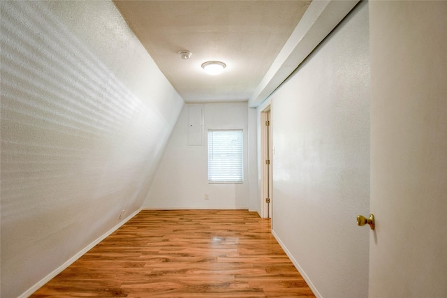 bonus room with light hardwood / wood-style floors and vaulted ceiling