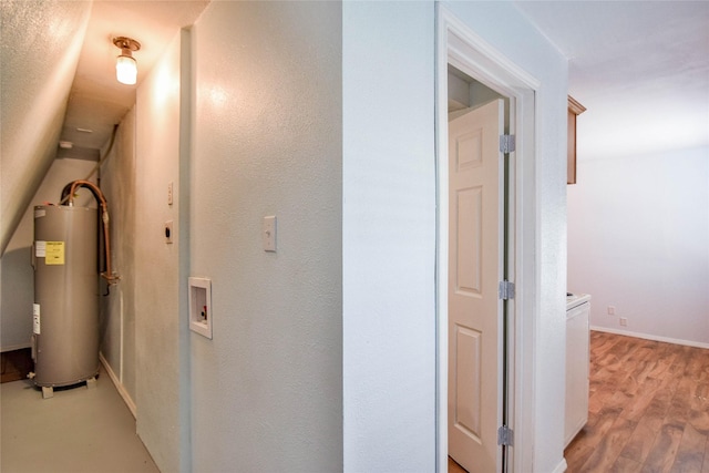 hallway with light hardwood / wood-style flooring and water heater