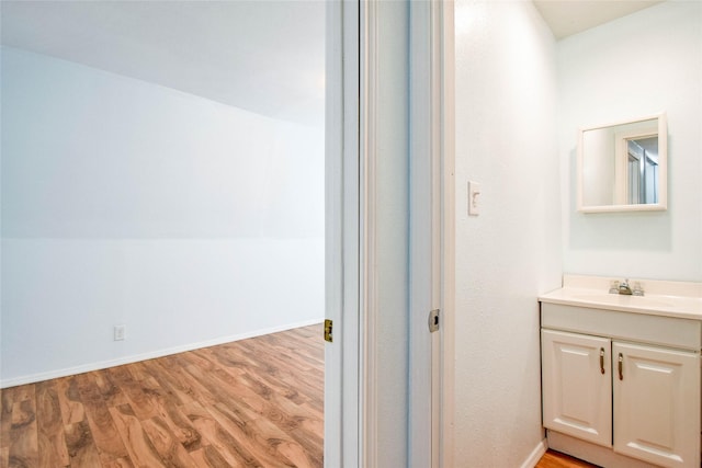 bathroom with vanity and wood-type flooring