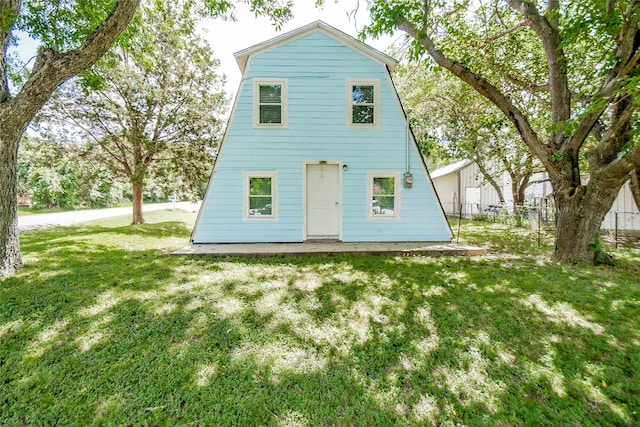 back of property featuring a lawn