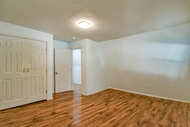 unfurnished bedroom with a closet and wood-type flooring