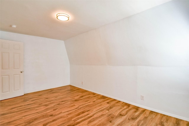 bonus room featuring light hardwood / wood-style flooring and lofted ceiling