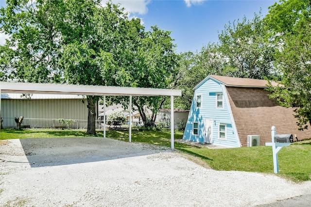 exterior space featuring a carport and a front lawn