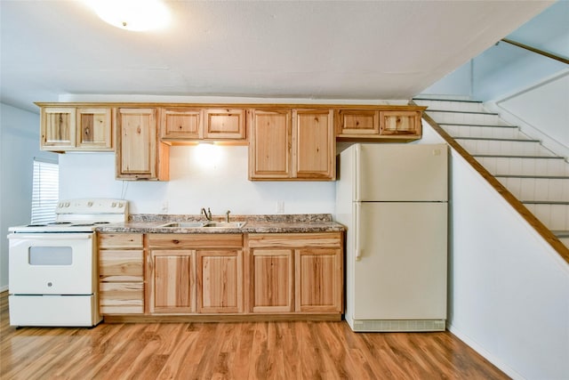 kitchen featuring sink, white appliances, and light wood-type flooring