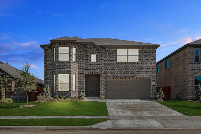 view of front of home featuring a yard and a garage