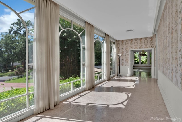 unfurnished sunroom featuring a healthy amount of sunlight