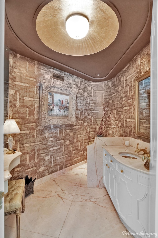 bathroom featuring vanity, a tray ceiling, and tile floors