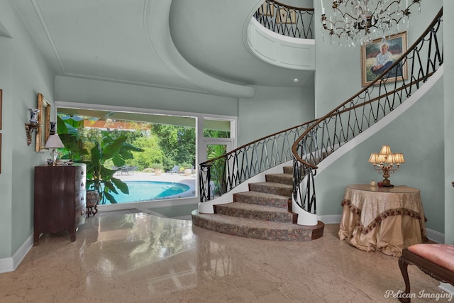 entrance foyer with a towering ceiling and a raised ceiling