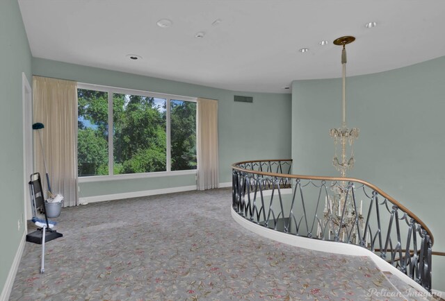 interior space with carpet flooring and a chandelier