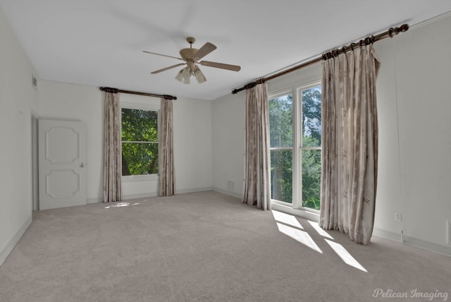 unfurnished room with carpet floors and ceiling fan