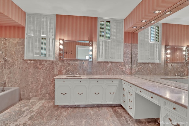 bathroom with tile floors, a bathtub, double vanity, and tile walls