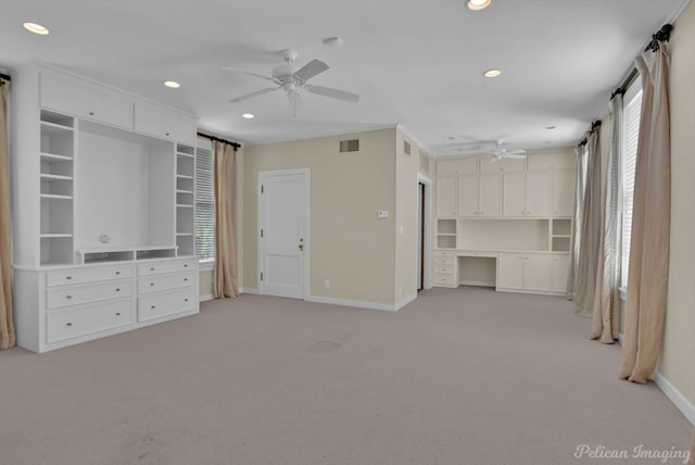 unfurnished living room with ceiling fan and carpet floors