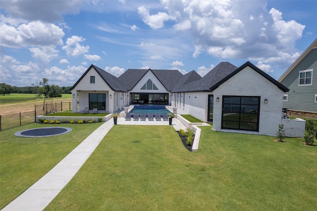 view of front of home featuring a fenced in pool, a patio area, and a front yard