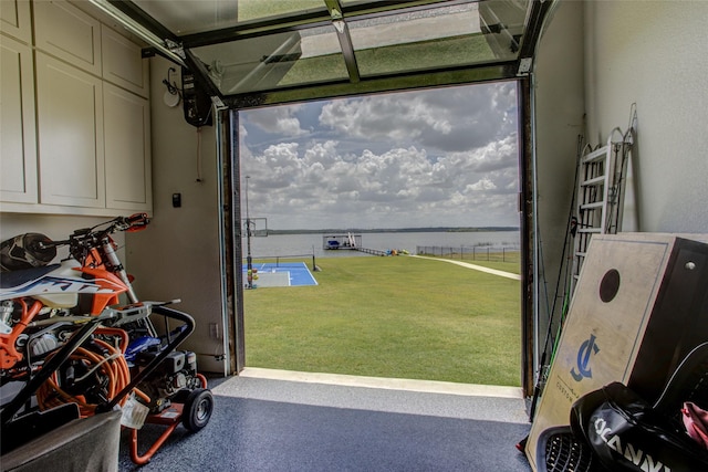 garage with a yard and a water view