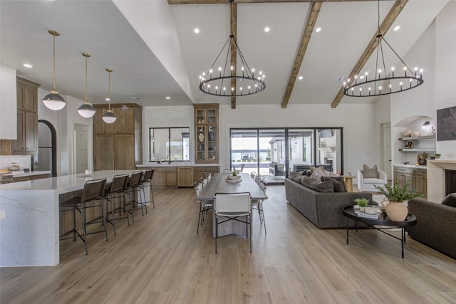 dining room featuring light hardwood / wood-style flooring, high vaulted ceiling, and beamed ceiling