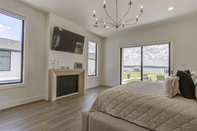 bedroom featuring hardwood / wood-style floors and a chandelier