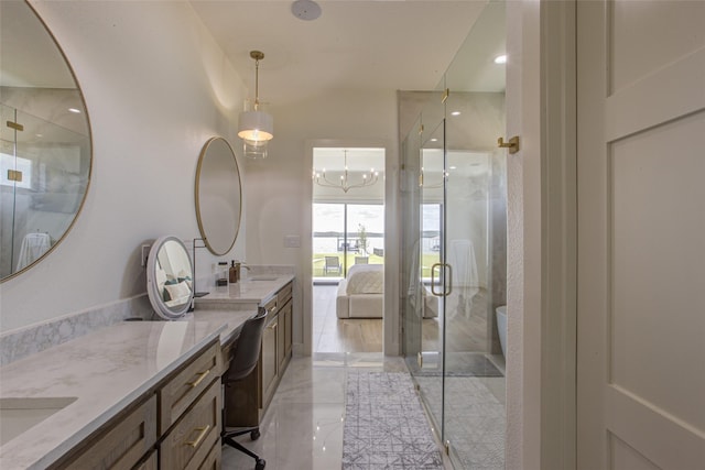 bathroom with vanity, an enclosed shower, and a chandelier