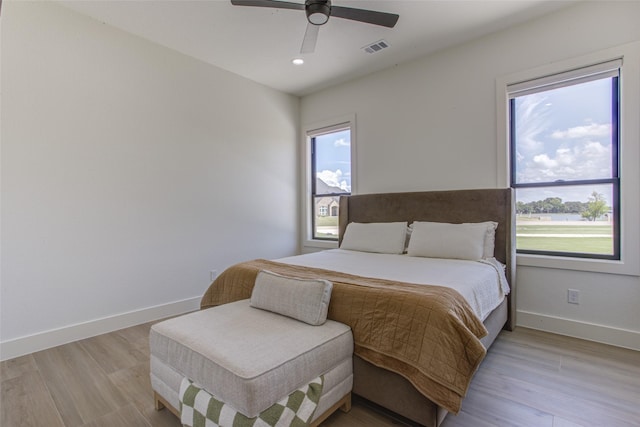 bedroom with ceiling fan and light hardwood / wood-style flooring