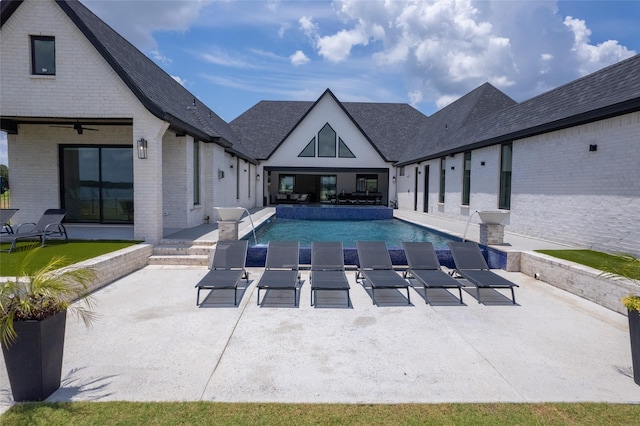 view of swimming pool with ceiling fan, pool water feature, and a patio