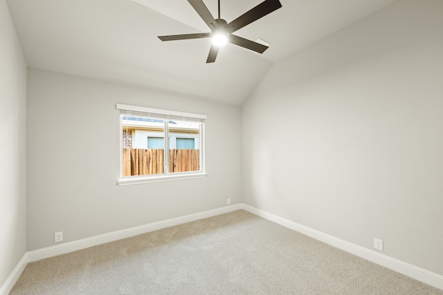 carpeted empty room with ceiling fan and lofted ceiling