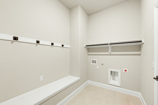 clothes washing area featuring electric dryer hookup, gas dryer hookup, washer hookup, and light tile patterned floors