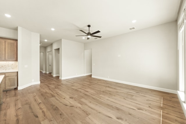 unfurnished living room with light wood-type flooring and ceiling fan